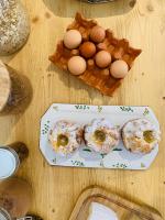 a table with donuts and eggs on a plate at La Grange aux Coqs in Ittenheim