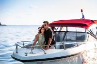 a man and woman standing on a boat in the water at Anantara Rasananda Koh Phangan Villas in Thong Nai Pan Noi