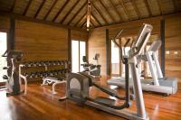 a gym with several treadmills and exercise bikes at Anantara Rasananda Koh Phangan Villas in Thong Nai Pan Noi