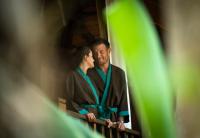a man and a woman standing in front of a mirror at Anantara Rasananda Koh Phangan Villas in Thong Nai Pan Noi