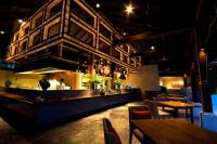 a restaurant with a bar with tables and chairs at Anantara Rasananda Koh Phangan Villas in Thong Nai Pan Noi