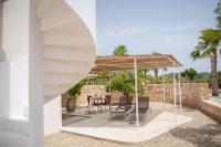 a patio with a table and chairs under a pavilion at Can Jaume by Ocean Drive in Ibiza Town