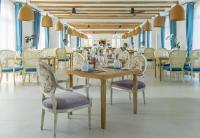 a dining room with a table and chairs at Risemount Premier Resort Da Nang in Da Nang