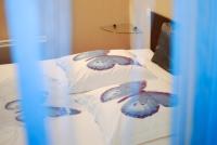 a bed with two pillows with butterflies on them at Chez Tatiana in Lyon