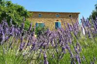 a field of purple flowers in front of a building at le mas du cypres, 12 pers et piscine in Aigaliers