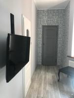 Televízia a/alebo spoločenská miestnosť v ubytovaní Stylowa Kamienica w Centrum