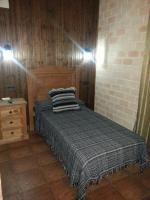 A bed or beds in a room at Posada de los Cónsules
