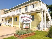 a yellow building with a sign for a beach motel at The Buckingham Motel Adults only in Cape May