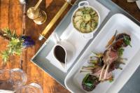 a plate of food with meat and vegetables on a table at The Goodwood Hotel in Chichester