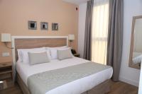 A bed or beds in a room at New Point Opera
