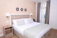 A bed or beds in a room at New Point Opera