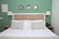 A bed or beds in a room at New Point Opera