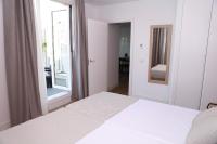 A bed or beds in a room at New Point Opera