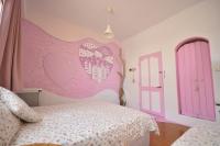 a bedroom with a bed with a pink heart wall at Sea House in Magong
