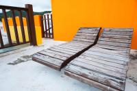 a wooden bench sitting on the side of a building at Kenting Shen&#39;s Homestay in Eluan