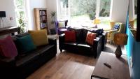 a living room with two couches and a table at The Benwiskin Centre in Ballaghnatrillick