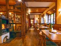 a restaurant with wooden floors and tables and chairs at Gasthaus & Hotel Drei Lilien in Werbach