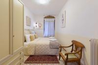 a bedroom with a bed and a chair at Hotel Mezzo Pozzo in Venice