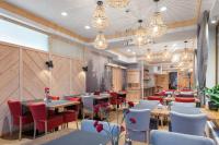 a restaurant with tables and chairs and chandeliers at Hotel Foluszowy Potok in Zakopane