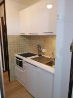 a kitchen with white cabinets and a sink at Plagne AIME 2000 Ski Apartments in Aime-La Plagne