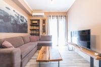 A television and/or entertainment centre at Stylish Luxury Apartment near Acropolis at Neos Kosmos metro station