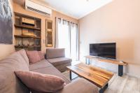 A television and/or entertainment centre at Stylish Luxury Apartment near Acropolis at Neos Kosmos metro station