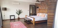 A bed or beds in a room at Fuego Design Suites