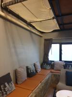 a room with couches and pillows on a train at Silom Space Hostel in Bangkok