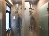 a bathroom with a shower and a glass door at Silom Space Hostel in Bangkok