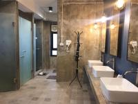 a bathroom with three sinks and two mirrors at Silom Space Hostel in Bangkok