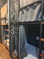a bunk bed with a iron gate in a room at Silom Space Hostel in Bangkok