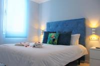 A bed or beds in a room at Aircon Las Americas 2min off a Beach 1 bedrm WIFI
