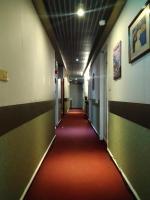 a hallway with a red carpet in an office building at Boston Hotel in Chiayi City