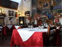 a table in a restaurant with a red and white table cloth at Ristorante Alloggio Ostello Amolara in Adria