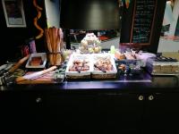 a buffet with pastries and other foods on a counter at Campanile Bayeux in Bayeux