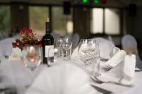 uma mesa com uma garrafa de vinho e copos de vinho em Park Villa Hotel em Vilnius