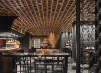 a restaurant with a bar with a coffered ceiling at New World Beijing Hotel in Beijing