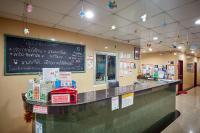 a restaurant counter with a chalkboard on the wall at Sivalai Place in Bangkok