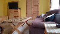 Televízia a/alebo spoločenská miestnosť v ubytovaní Apartament Grota