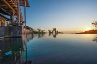 a large pool of water with the sunset in the background at Rinjani Lodge in Senaru