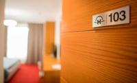a hotel room with a sign on a wooden wall at Holiday Resort in Velika Slatina