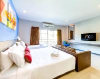 Postel nebo postele na pokoji v ubytování FX Hotel Pattaya
