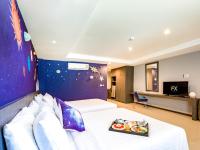 Postel nebo postele na pokoji v ubytování FX Hotel Pattaya