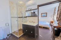 a bathroom with a shower and a sink and a bed at AU BEAU RIVAGE AP2049 by RIVIERA HOLIDAY HOMES in Nice