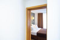 a bedroom with a bed and a mirror at Hôtel Le Rapp in Colmar