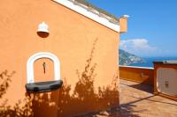 a building with a door with the ocean in the background at Villa Ambra Positano in Positano
