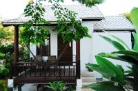a porch of a house with a swing at Sarikantang Resort & Spa, Koh Phangan in Haad Rin