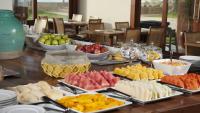 a table topped with lots of different types of food at Jatiuca Hotel & Resort in Maceió