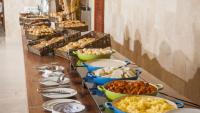 a buffet with bowls of food on a table at Jatiuca Hotel & Resort in Maceió