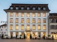 a large white building with tables in front of it at Boutique Hotel La Couronne in Solothurn